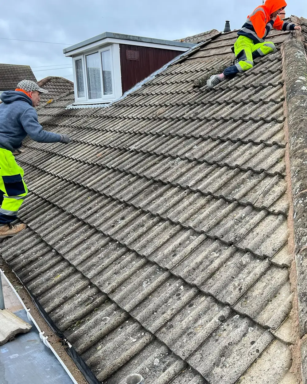 Crest roofers working on a tiled roof